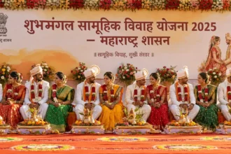 शुभमंगल सामूहिक विवाह योजनेंतर्गत महाराष्ट्रात आयोजित सामूहिक विवाह सोहळ्यात पारंपरिक वेशभूषेतील जोडपी मंचावर बसलेली असून पार्श्वभूमीवर महाराष्ट्र सरकारचा बॅनर दिसत आहे